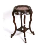 A late 19th century walnut plant stand with inset rouge marble top, 37cms (14.5ins) diameter.