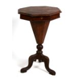 A Victorian walnut octagonal trumpet work table, on tripod base, 44cms (17.5ins) wide.