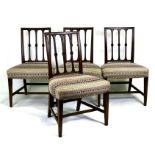 A set of four 19th century mahogany dining chairs with overstuffed seats, on tapering square legs