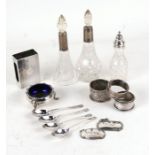 A quantity of silver and silver mounted items to include salts, scent bottles and napkin rings.