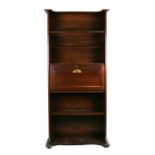 An Arts & Crafts style open bookcase having a secretaire with fitted interior, 76cms (30ins) wide.