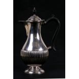A George VI silver water jug of baluster form in the 18th century style, with reeded body and turned
