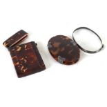 A Victorian tortoiseshell card case; together with a tortoiseshell magnifying glass (2).Condition