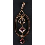 A gold and garnet Art Nouveau style pendant. 1.3gCondition Reportnot hallmarked