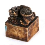 A Chinese soapstone seal surmounted with a mythical beast, 5cms (2ins) high.