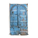 An Indian wooden window shutter door with carved decoration, 66cms (26ins) wide.
