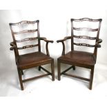 A pair of 19th century mahogany carver chairs with drop-in seats, on square chamfered legs.