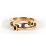 A 9ct gold modern design ring set with a central amethyst, approx UK size 'M', 4g.