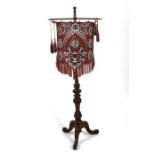 A 19th century mahogany pole screen on tripod base. 140cm (55 ins) high 52cm (20.5 ins)