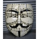 A large enamel decorative plaque in the form of a head, of riveted construction, 77cms (30.5ins)