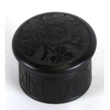 A Victorian Irish bog oak box decorated with shamrocks, 4cms (1.5ins) diameter.