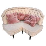 An Edwardian button backed upholstered corner sofa on ring turned front supports, 153cms (60ins)