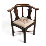 A George III beech corner chair with twin vase shaped back splats, drop-in seat and square chamfered