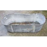 A large galvanised tin bath, 121cms (47.5ins) long.Condition Reportmisshapen and rusted holes to the