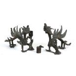 A pair of Chinese bronze dragon candlesticks, 17cms (6.75ins) wide.