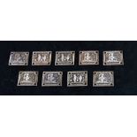 A group of nine Chinese white metal plaques, each decorated with figures and calligraphy (possibly