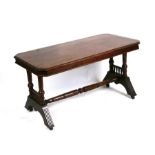 An Edwardian rectangular occasional table on ring turned supports joined by a stretcher, 98cms (38.