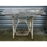 A cast iron garden table with slate rectangular top, 107cms (42ins) wide.