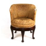 A late 19th century Georgian style mahogany tub chair with three cabriole front legs on paw feet.