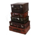 A group of five suitcases to include two leather, the largest 66cms (26ins) wide (5).