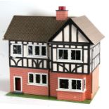 A 1930's Tri-Ang mock Tudor two storey dolls house. together with some furniture and accessories