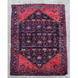 A Persian Hamadan rug with geometric floral design within multi borders, 125 by 200cms (49 by