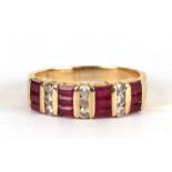 A 14ct gold diamond and ruby ring set with twelve baguette cut rubies and nine diamonds, approx UK