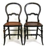 A pair of Victorian ebonised balloon back parlour chairs with mother of pearl inlay and cane