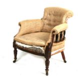 A Victorian mahogany tub armchair with turned supports and front legs.