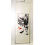 A Chinese scroll painting depicting carp and calligraphy, 51 by 95cms (20 by 37.5ins).