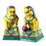 A large pair of Chinese porcelain famille jaune Buddhist lion dogs, 36cms (14ins) high.