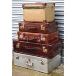 Three leather suitcases, the largest 81cms (32ins) wide; together with a polished aluminium