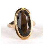 A 9ct gold ring set with a large oval smoky quartz, approx UK size 'L', 4.5g.