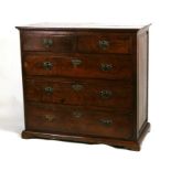 A 19th century oak chest of drawers with two short and three long graduated drawers, on a plinth