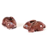 A pair of Chinese glazed pottery rabbits, 6cms (2.25ins) long.