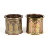 A matched pair of Persian brass and copper pots with traditional decoration, each 7cms (3ins) high.