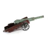 An early 1920s metal toy firing cannon mounted on a metal wagon. The overall barrel length is