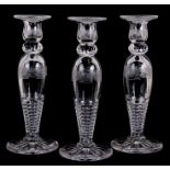 A set of three Baccarat style glass baluster form candlesticks with acid etched decoration, 30cms (