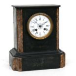 A Victorian black slate mantle clock, the white enamel dial with Roman numerals, fitted with an 8-