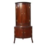 A 19th century mahogany bow fronted corner cupboard on stand, the pair of doors above two short