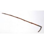 A late 19th / early 20th century Chinese twisted wooden riding crop with white metal handle,