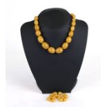 A graduated string of amber like beads.Condition ReportNecklace length 42cms (16.5ins) and weight