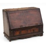 A 19th century miniature mahogany and crossbanded table top bureau, with fall front revealing