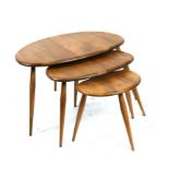 A nest of three mid 20th century Ercol blonde Pebble tables, the largest 65cms (25.5ins) wide.