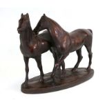 A bronzed plaster group depicting two horses, 51cms (20ins) wide.