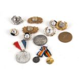 A quantity of Marine cap badges and medals to include a pair of miniatures and Coronation medal.