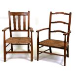 A Sussex Arts & Crafts style oak armchair with rush seat; together with another similar (2).