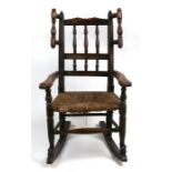 A Victorian beech child's rocking chair with rush seat.