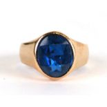 A gold signet ring set with a large oval faceted blue stone, approx UK size 'J', 4.2g.