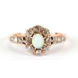 An 18ct gold opal and diamond flower head ring with diamond set shoulders, approx UK size 'L'.